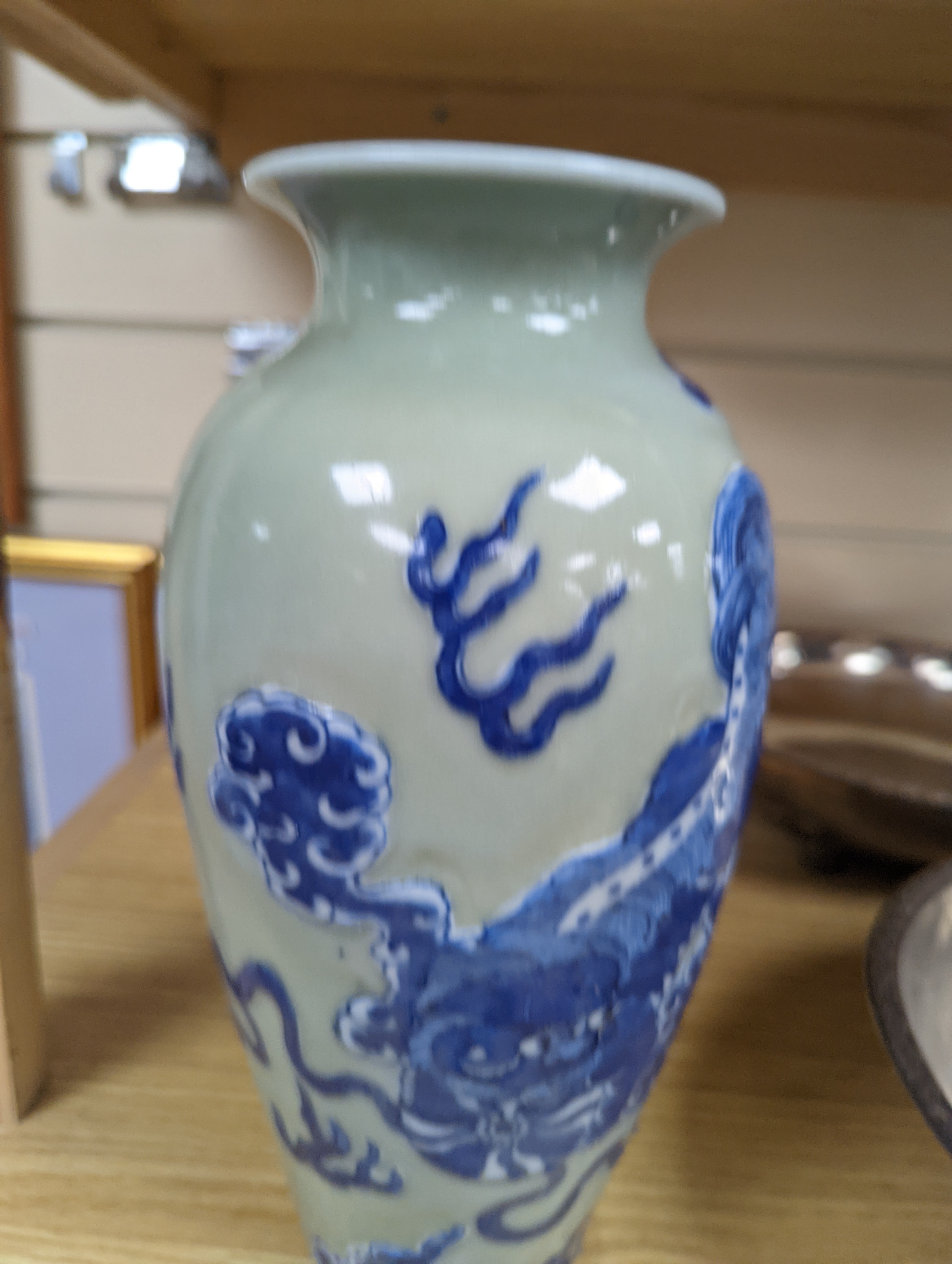 A Chinese celadon glazed vase, 24cm and a Chinese famille rose teapot and matching cream jug, a.f.